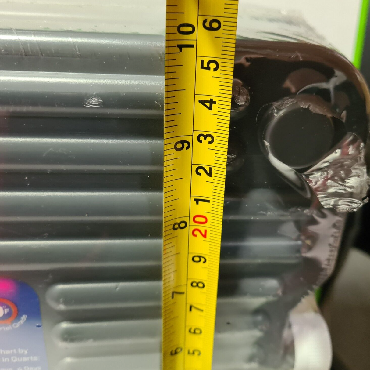 Measuring the width of a clear extra large hard ice pack for cooler, showcasing its robust design.