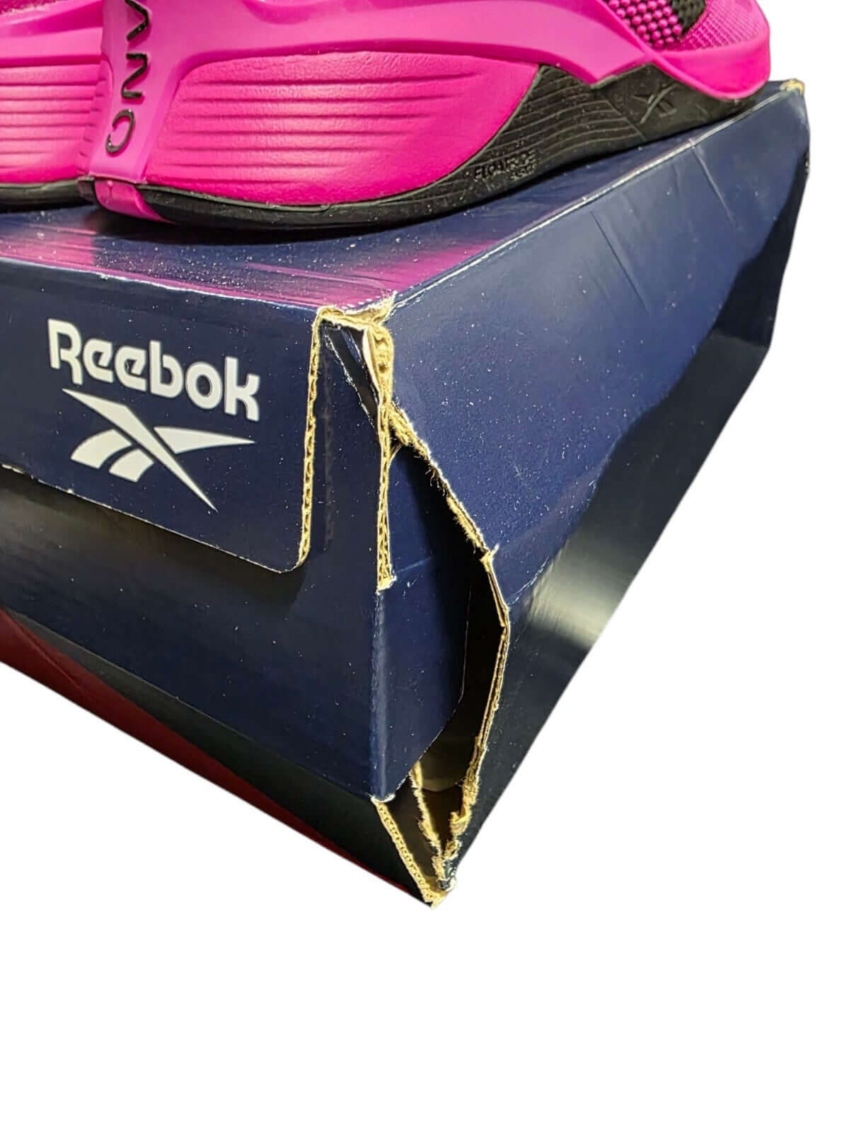Reebok Nano X4 women's training shoes showcased on damaged box, vibrant pink color, perfect for workouts and fitness activities.