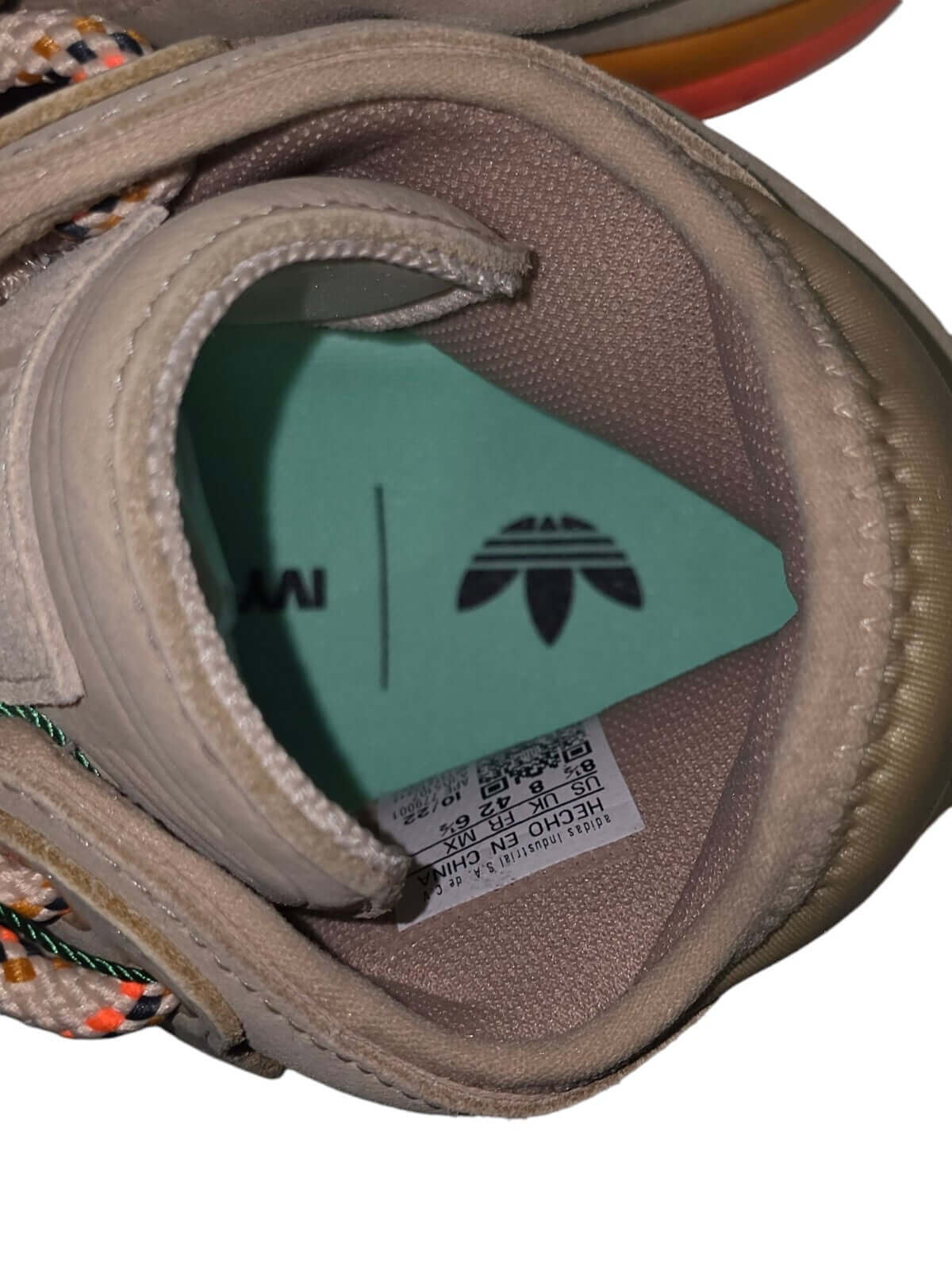 Inside view of Adidas Ivy Park Top Ten 2000 basketball shoe showing tag and insole details.