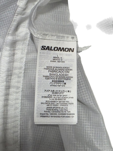 Salomon men’s vest care label showing manufacturing details and size information, designed for running enthusiasts.
