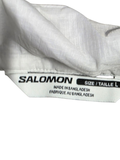 Salomon vest size label showing L for large, made in Bangladesh, part of lightweight running apparel.